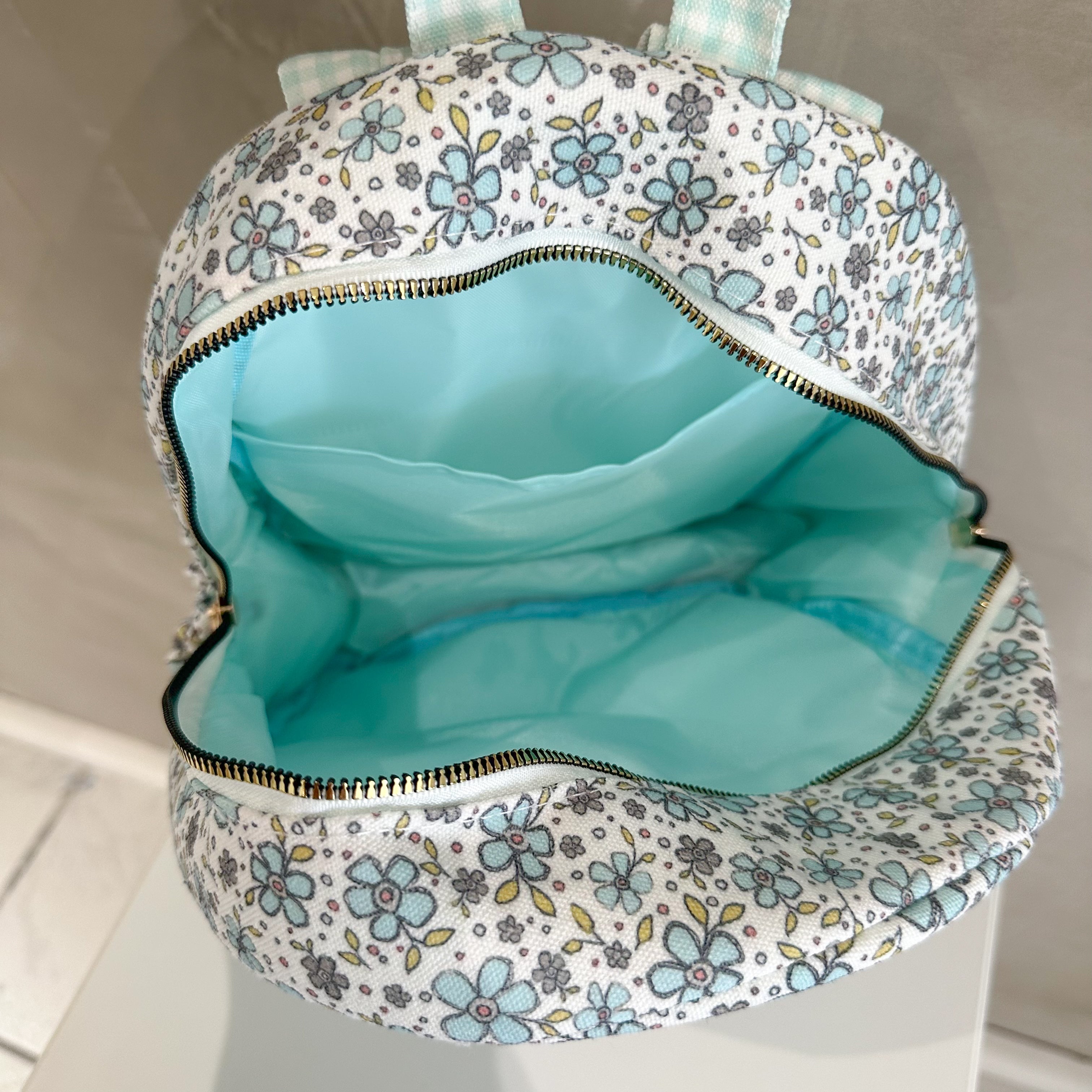 TURQUOISE FLORAL RUFFLE BACKPACK